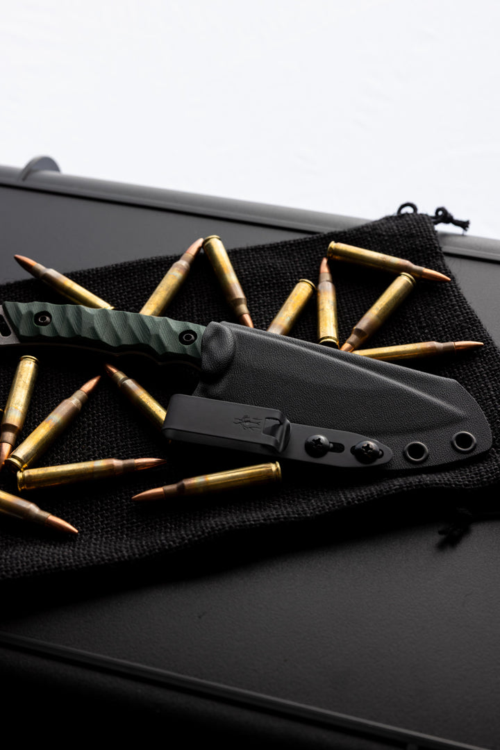 Warlord, The Dagr and Nott fixed blade with forest green g10 staged for a photo.