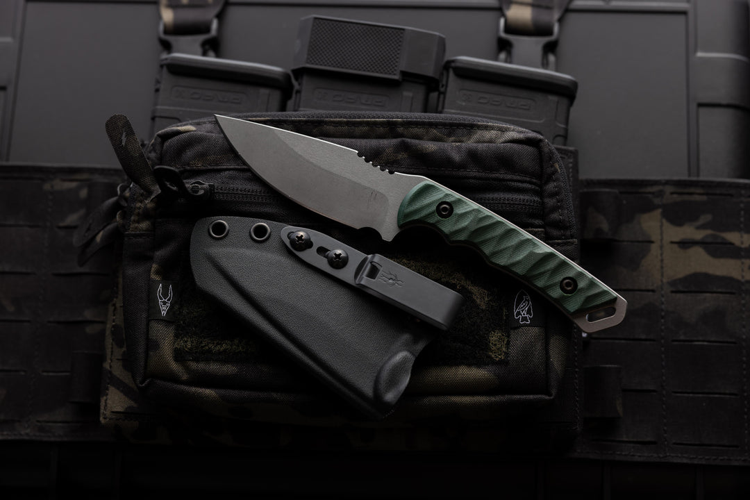 The Magnacut Warlord (Stonewashed Edition) a Dagr and Nott fixed blade shown with it's sheathe.