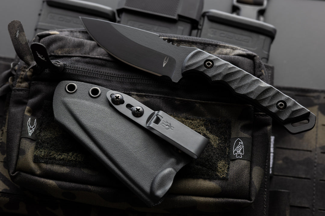 Dagr & Nott Warlord fixed blade in Magnacut, featuring a tactical chest rig.
