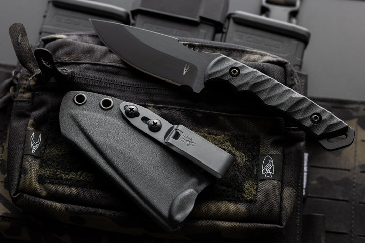 Dagr & Nott Warlord fixed blade in Magnacut, featuring a tactical chest rig.
